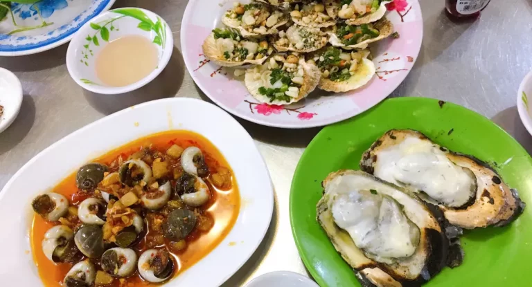 Snails skewers and seafood local food in Ho Chi Minh City by AN Tour Vietnam