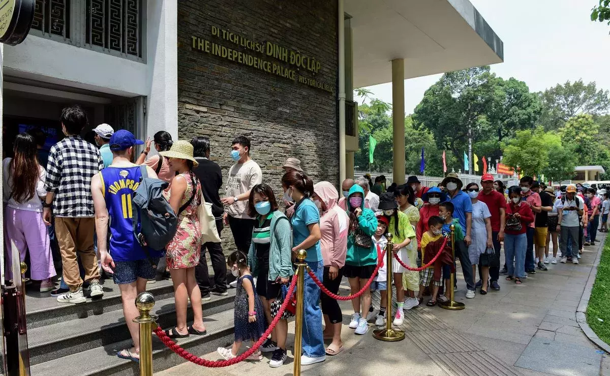 Visitors line up to buy entry tickets at Independence Palace