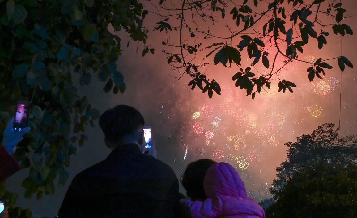 People in Hanoi enjoy fireworks during previous Lunar New Year