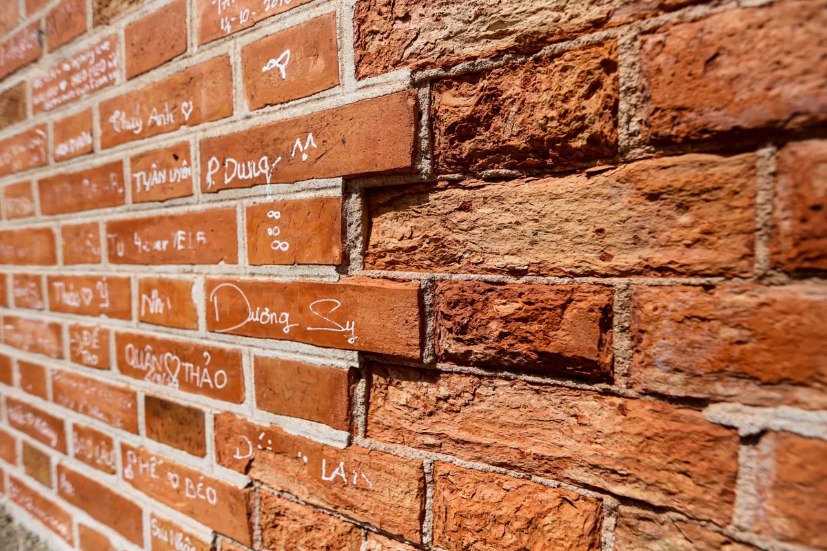 The bricks are still bright pink in color but have also been partially damaged. Many bricks were covered in writing and graffiti.
