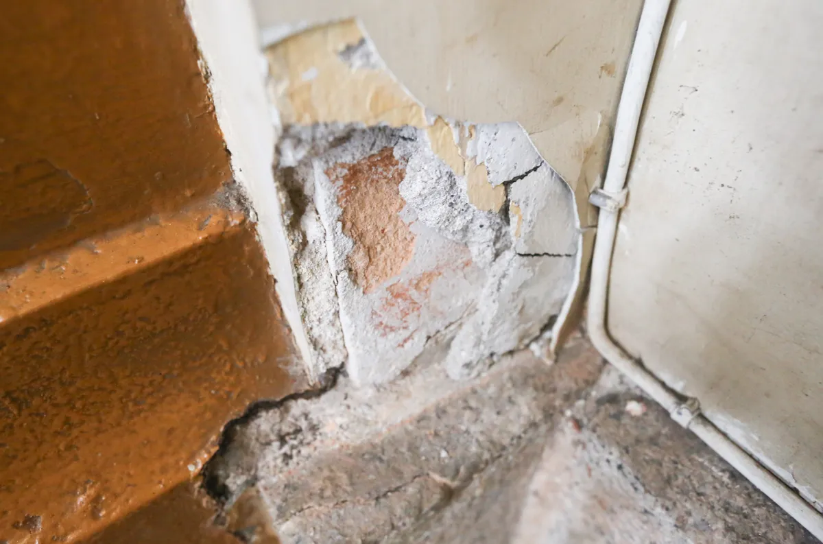 The plaster on the walls and ceiling of the church is peeling off