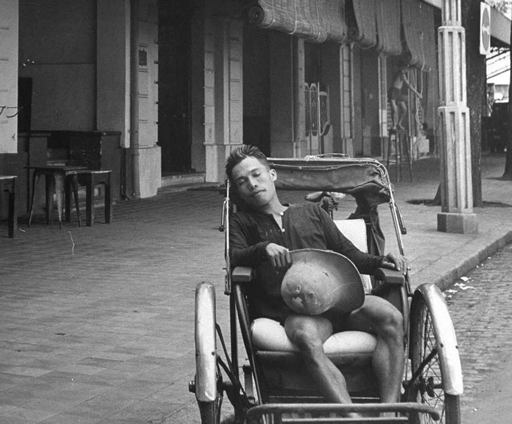 A cyclo driver slept while waiting for customers - Saigon in mid-late 20th century