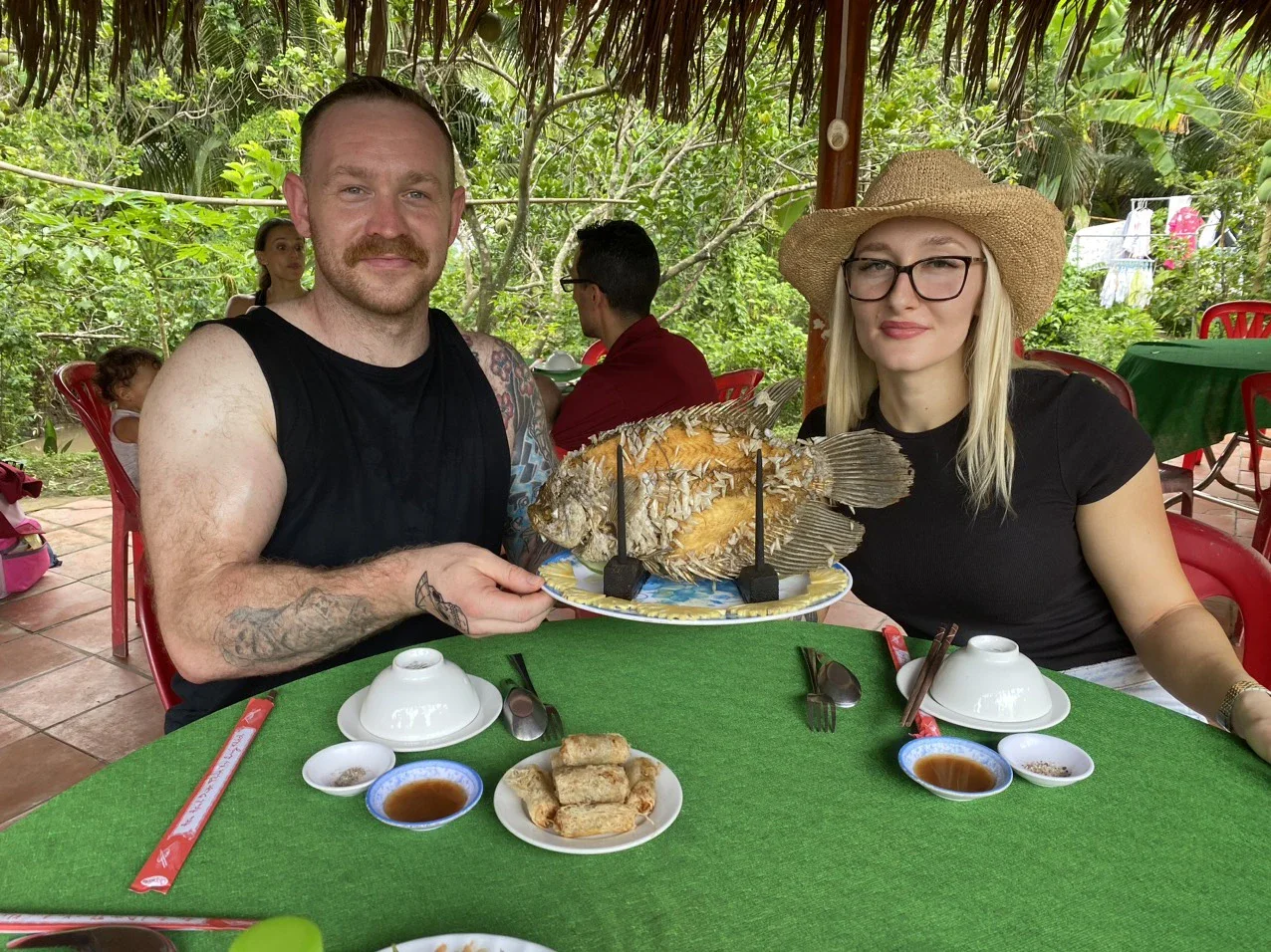 A couple of foreign tourists enjoy food in Vietnam