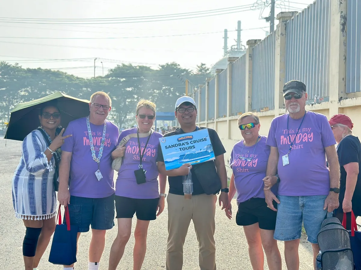Some of the Carnival Panorama cruisers took photos with our lovely tour guide