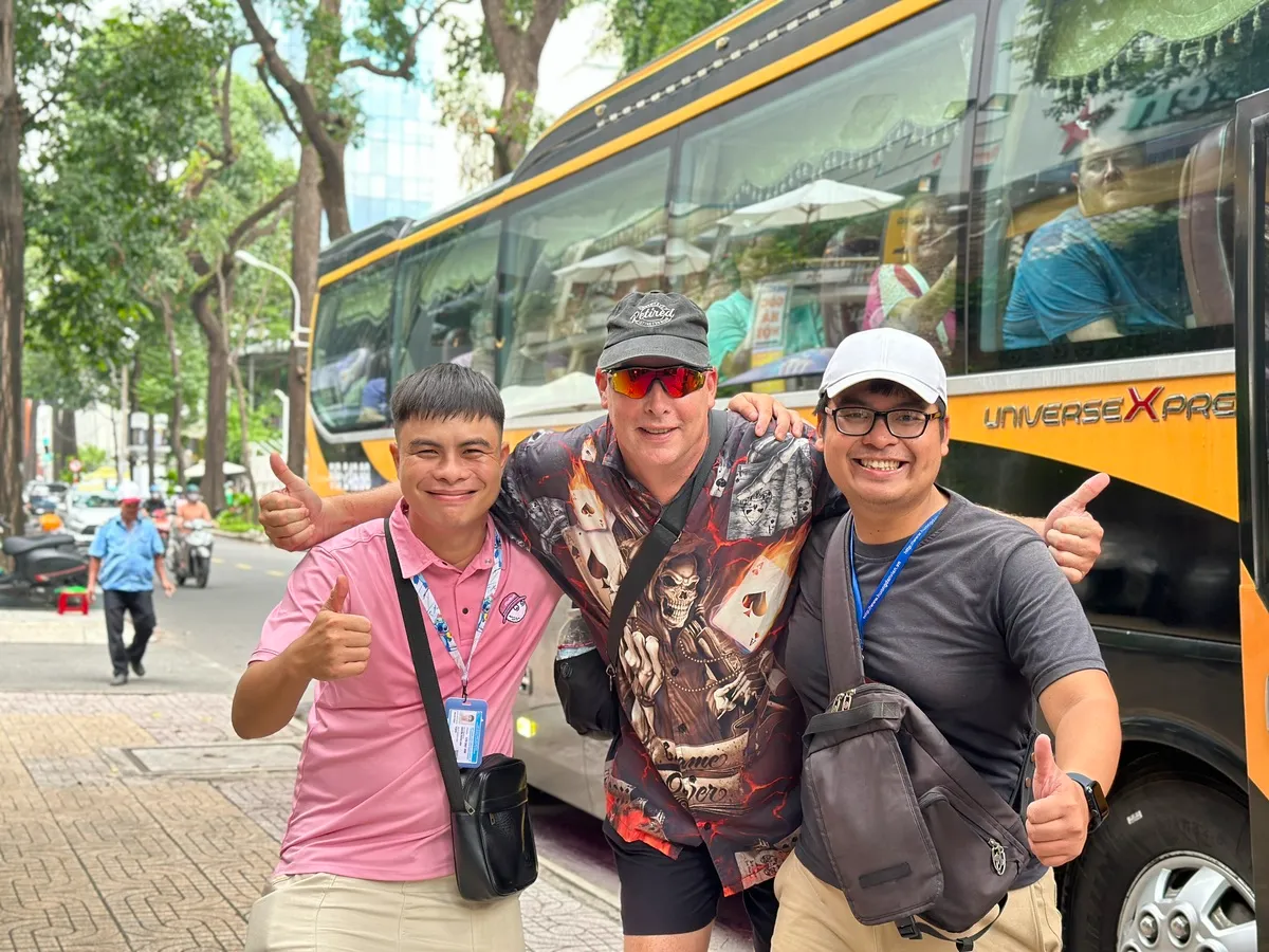 Taking a fun photo with tour guides from AN Tours Vietnam
