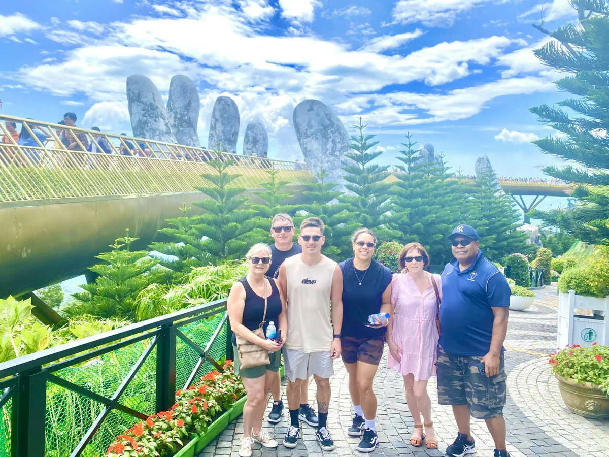 Tour guests beside the Golden Bridge at Ba Na Hills
